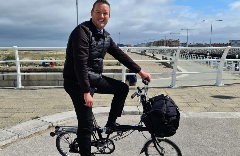 Gareth Davies MS tests a folding bike on the cycle path at Rhyl harbour